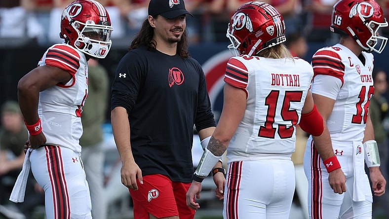 Nov 18, 2023; Tucson, Arizona, USA; Utah Utes quarterback Cameron Rising (middle) on the field during warms ups with quarterback Bryson Barnes (16), quarterback Nate Johnson (13) and quarterback Luke Bottari (15) at Arizona Stadium. Mandatory Credit: Zachary BonDurant-USA TODAY Sports