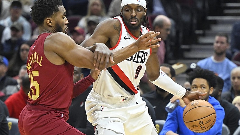 Nov 30, 2023; Cleveland, Ohio, USA; Portland Trail Blazers forward Jerami Grant (9) drives against Cleveland Cavaliers guard Donovan Mitchell (45) in the second quarter at Rocket Mortgage FieldHouse. Mandatory Credit: David Richard-USA TODAY Sports