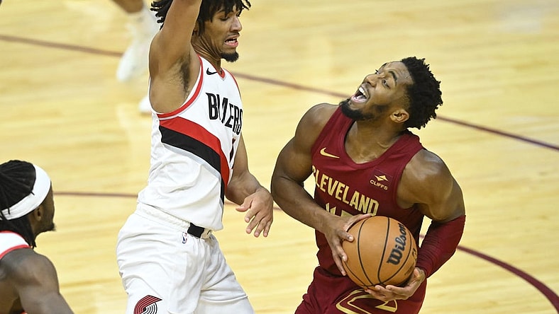Nov 30, 2023; Cleveland, Ohio, USA; Cleveland Cavaliers guard Donovan Mitchell (45) collides with Portland Trail Blazers guard Shaedon Sharpe (17) in the fourth quarter at Rocket Mortgage FieldHouse. Mandatory Credit: David Richard-USA TODAY Sports