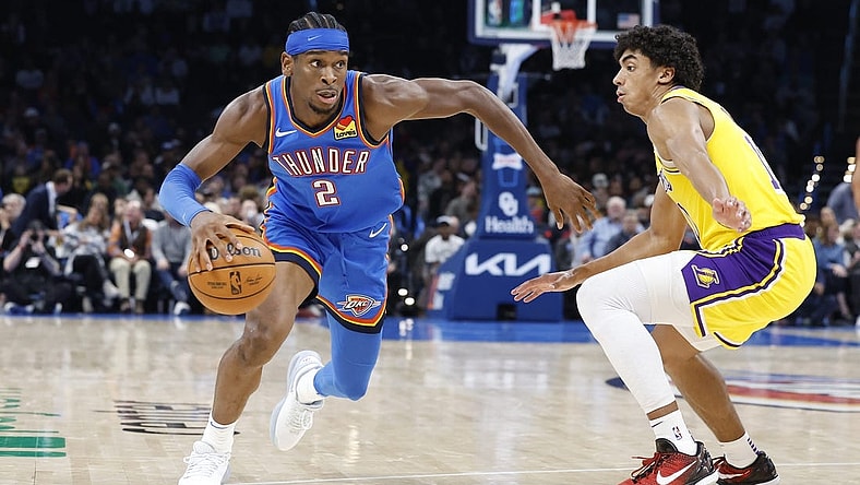 Nov 30, 2023; Oklahoma City, Oklahoma, USA; Oklahoma City Thunder guard Shai Gilgeous-Alexander (2) drives around Los Angeles Lakers guard Max Christie (10) during the second half at Paycom Center. Mandatory Credit: Alonzo Adams-USA TODAY Sports
