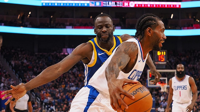 Nov 30, 2023; San Francisco, California, USA; Los Angeles Clippers forward Kawhi Leonard (2) controls the ball against Golden State Warriors forward Draymond Green (23) during the second quarter at Chase Center. Mandatory Credit: Kelley L Cox-USA TODAY Sports