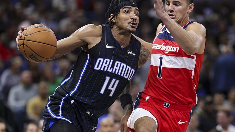 Dec 1, 2023; Orlando, Florida, USA;  Orlando Magic guard Gary Harris (14) drives to the basket past Washington Wizards guard Johnny Davis (1) in the second quarter at Amway Center. Mandatory Credit: Nathan Ray Seebeck-USA TODAY Sports