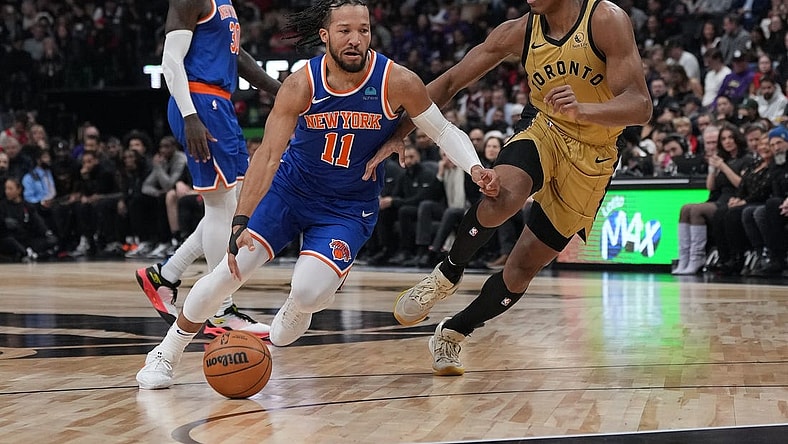 Dec 1, 2023; Toronto, Ontario, CAN; New York Knicks guard Jalen Brunson (11) controls the ball as Toronto Raptors forward Scottie Barnes (4) tries to defend during the first quarter at Scotiabank Arena. Mandatory Credit: Nick Turchiaro-USA TODAY Sports