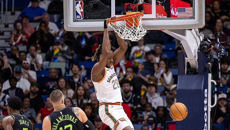 Dec 1, 2023; New Orleans, Louisiana, USA; San Antonio Spurs center Charles Bassey (28) dunks the ball against New Orleans Pelicans center Jonas Valanciunas (17) during the first half at the Smoothie King Center. Mandatory Credit: Stephen Lew-USA TODAY Sports