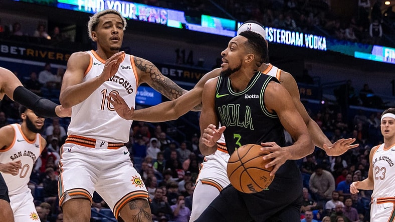 Dec 1, 2023; New Orleans, Louisiana, USA; New Orleans Pelicans guard CJ McCollum (3) dribbles against San Antonio Spurs guard Malaki Branham (22) during the first half at the Smoothie King Center. Mandatory Credit: Stephen Lew-USA TODAY Sports