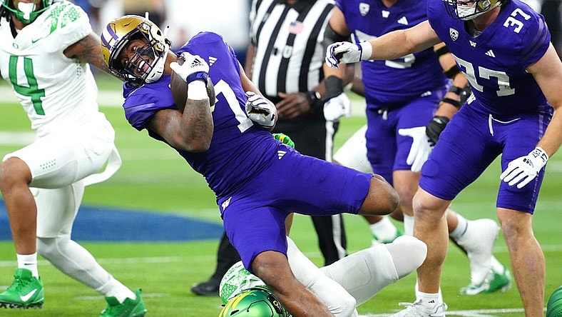 Dec 1, 2023; Las Vegas, NV, USA; Washington Huskies running back Dillon Johnson (7) gains yards against the Oregon Ducks during the first quarter at Allegiant Stadium. Mandatory Credit: Stephen R. Sylvanie-USA TODAY Sports