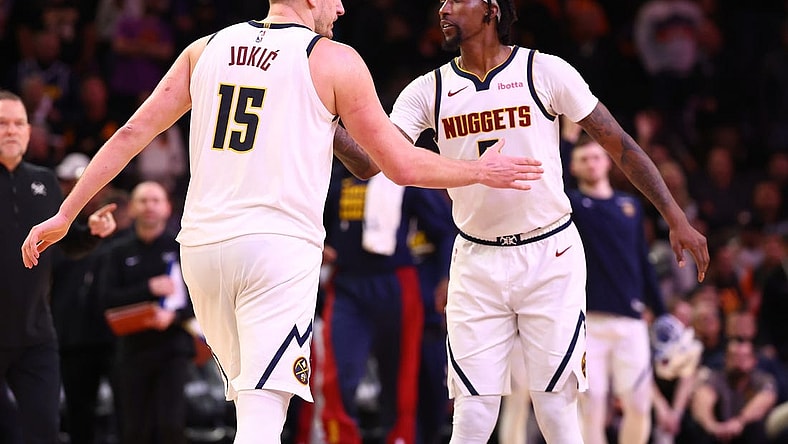 Dec 1, 2023; Phoenix, Arizona, USA; Denver Nuggets center Nikola Jokic (15) celebrates with guard Kentavious Caldwell-Pope (5) against the Phoenix Suns in the second half at Footprint Center. Mandatory Credit: Mark J. Rebilas-USA TODAY Sports