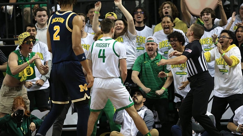 Oregon   s Brennan Rigsby, center, celebrates with Duck fans during the first half of their game against Michigan at Matthew Knight Arena in Eugene Saturday, Dec 2, 2023.