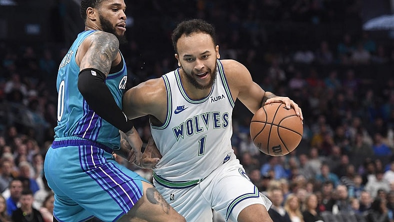 Dec 2, 2023; Charlotte, North Carolina, USA;  Minnesota Timberwolves forward Kyle Anderson (1) drives past Charlotte Hornets forward Miles Bridges (0) during the first half at the Spectrum Center. Mandatory Credit: Sam Sharpe-USA TODAY Sports