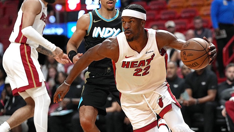 Dec 2, 2023; Miami, Florida, USA;  Miami Heat forward Jimmy Butler (22) grabs a rebound against the Indiana Pacers during the first half at Kaseya Center. Mandatory Credit: Jim Rassol-USA TODAY Sports