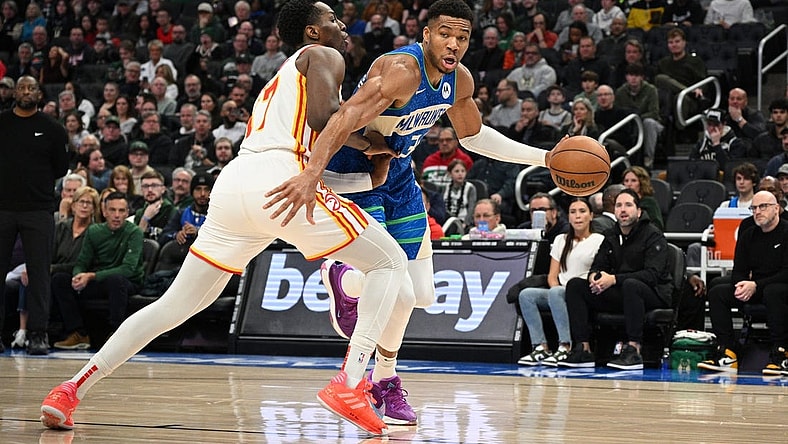 Dec 2, 2023; Milwaukee, Wisconsin, USA; Milwaukee Bucks forward Giannis Antetokounmpo (34) drives the baseline against Atlanta Hawks forward Onyeka Okongwu (17) in the first half at Fiserv Forum. Mandatory Credit: Michael McLoone-USA TODAY Sports