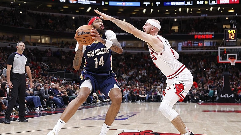Dec 2, 2023; Chicago, Illinois, USA; New Orleans Pelicans forward Brandon Ingram (14) looks to shoot against Chicago Bulls guard Alex Caruso (6) during the first half at United Center. Mandatory Credit: Kamil Krzaczynski-USA TODAY Sports
