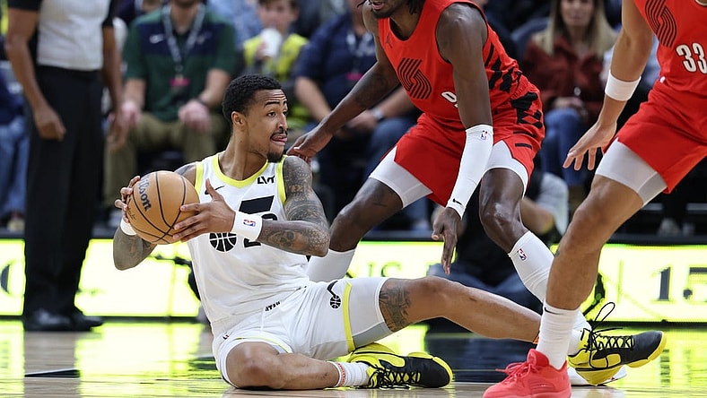 Dec 2, 2023; Salt Lake City, Utah, USA; Utah Jazz forward John Collins (20) plays a ball from the floor against Portland Trail Blazers forward Jerami Grant (9) during the first quarter at Delta Center. Mandatory Credit: Rob Gray-USA TODAY Sports