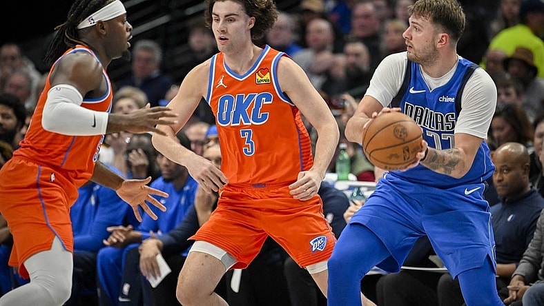 Dec 2, 2023; Dallas, Texas, USA; Dallas Mavericks guard Luka Doncic (77) looks to pass the ball past Oklahoma City Thunder guard Josh Giddey (3) during the second quarter at the American Airlines Center. Mandatory Credit: Jerome Miron-USA TODAY Sports