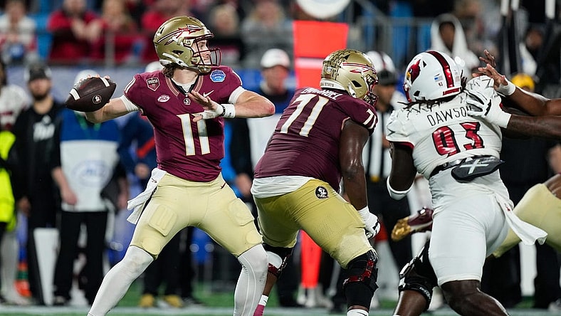 Dec 2, 2023; Charlotte, NC, USA; Florida State Seminoles quarterback Brock Glenn (11) throws against the Louisville Cardinals during the second quarter at Bank of America Stadium. Mandatory Credit: Jim Dedmon-USA TODAY Sports