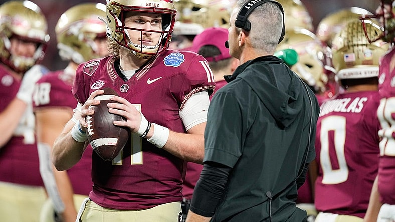 Dec 2, 2023; Charlotte, NC, USA; Florida State Seminoles quarterback Brock Glenn (11) speaks to head coach Mike Norvell on the sidelines during the third quarter against the Louisville Cardinals at Bank of America Stadium. Mandatory Credit: Jim Dedmon-USA TODAY Sports