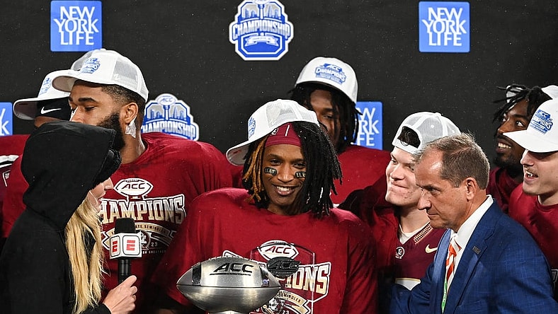 Dec 2, 2023; Charlotte, NC, USA; Florida State Seminoles running back Lawrance Toafili (9) is awarded the ACC Championship MVP trophy after the game against the Louisville Cardinals at Bank of America Stadium. Mandatory Credit: Bob Donnan-USA TODAY Sports