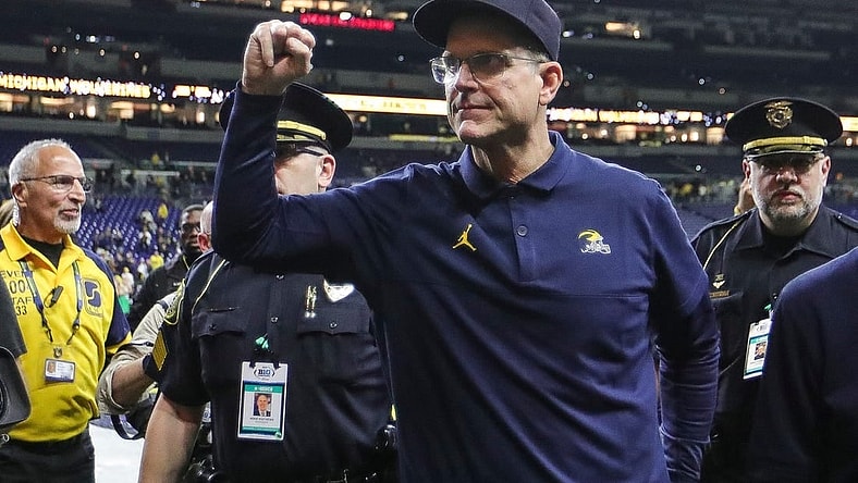 Michigan football coach Jim Harbaugh waves at fans after the Wolverines' 26-0 win over Iowa in the Big Ten championship game in Indianapolis on Dec. 2, 2023.
