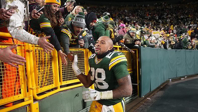 Dec 3, 2023; Green Bay, Wisconsin, USA; Green Bay Packers running back AJ Dillon (28) makes a victory lap after their game against the Kansas City Chiefs at Lambeau Field. Mandatory Credit: Mark Hoffman-USA TODAY Sports