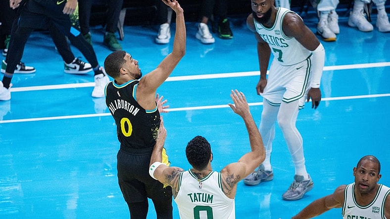 Dec 4, 2023; Indianapolis, Indiana, USA; Indiana Pacers guard Tyrese Haliburton (0) shoots while Boston Celtics forward Jayson Tatum (0)  defends in the first quarter at Gainbridge Fieldhouse. Mandatory Credit: Trevor Ruszkowski-USA TODAY Sports