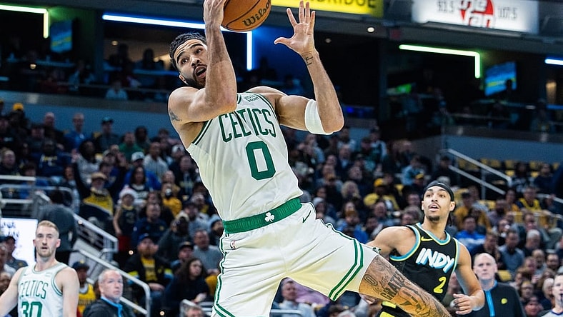 Dec 4, 2023; Indianapolis, Indiana, USA; Boston Celtics forward Jayson Tatum (0) rebounds the ball in the first half against the Indiana Pacers at Gainbridge Fieldhouse. Mandatory Credit: Trevor Ruszkowski-USA TODAY Sports