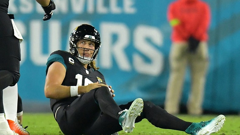 Jacksonville Jaguars quarterback Trevor Lawrence (16) looks up at a teammate after getting tackled by Cincinnati Bengals defensive end Sam Hubbard (94) late in the second quarter. The Jacksonville Jaguars hosted the Cincinnati Bengals at EverBank Stadium in Jacksonville, Florida for Monday Night Football, December 4, 2023. The Jaguars were tied 14 to 14 at the end of the first half. [Bob Self/Florida Times-Union]