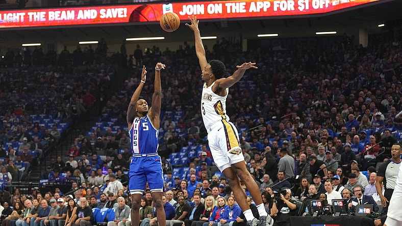 Dec 4, 2023; Sacramento, California, USA; Sacramento Kings guard De'Aaron Fox (5) shoots against New Orleans Pelicans forward Herbert Jones (5) during the first quarter at Golden 1 Center. Mandatory Credit: Darren Yamashita-USA TODAY Sports