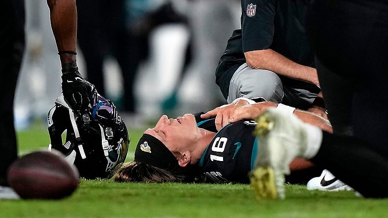 Jacksonville Jaguars quarterback Trevor Lawrence (16) is examined on the field after suffering a leg injury in the fourth quarter of a Week 13 NFL football game against the Cincinnati Bengals, Monday, Dec. 4, 2023, at EverBank Stadium in Jacksonsville, Fla.
