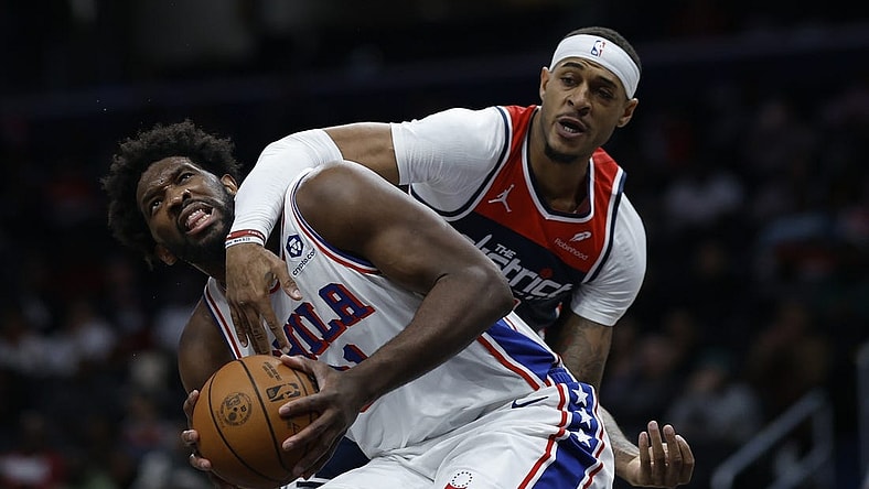 Dec 6, 2023; Washington, District of Columbia, USA; Philadelphia 76ers center Joel Embiid (21) is fouled by Washington Wizards center Daniel Gafford (21) in the second quarter at Capital One Arena. Mandatory Credit: Geoff Burke-USA TODAY Sports