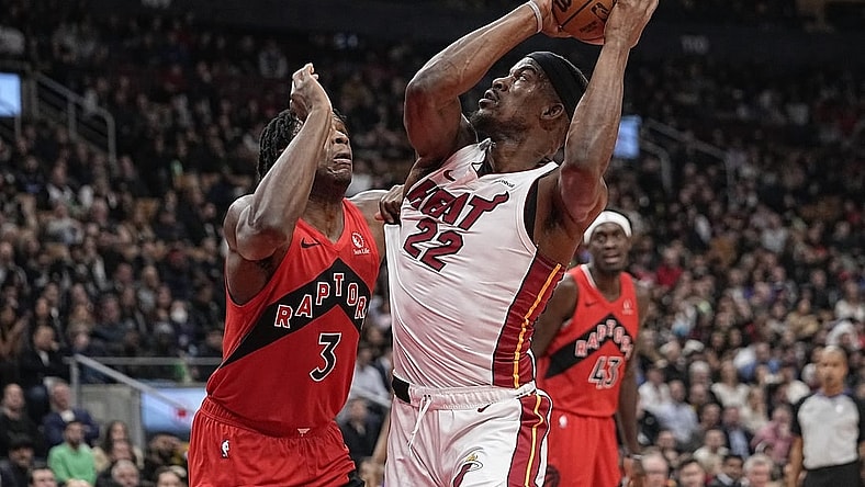 Dec 6, 2023; Toronto, Ontario, CAN; Miami Heat forward Jimmy Butler (22) tries to make a basket against Toronto Raptors forward O.G. Anunoby (3) during the first half at Scotiabank Arena. Mandatory Credit: John E. Sokolowski-USA TODAY Sports