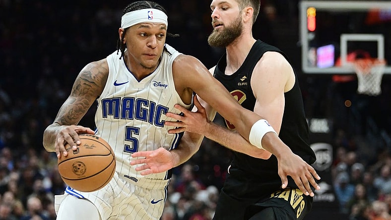 Dec 6, 2023; Cleveland, Ohio, USA; Orlando Magic forward Paolo Banchero (5) drives to the basket against Cleveland Cavaliers forward Dean Wade (32) during the first half at Rocket Mortgage FieldHouse. Mandatory Credit: Ken Blaze-USA TODAY Sports