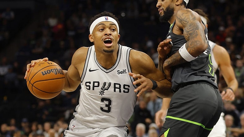 Dec 6, 2023; Minneapolis, Minnesota, USA; San Antonio Spurs forward Keldon Johnson (3) works against Minnesota Timberwolves guard Nickeil Alexander-Walker (9) in the first quarter at Target Center. Mandatory Credit: Bruce Kluckhohn-USA TODAY Sports