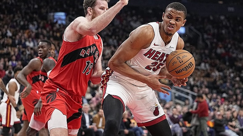 Dec 6, 2023; Toronto, Ontario, CAN; Miami Heat center Orlando Robinson (25) tries to around Toronto Raptors center Jakob Poeltl (19) during the first half at Scotiabank Arena. Mandatory Credit: John E. Sokolowski-USA TODAY Sports