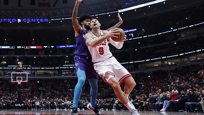 Dec 6, 2023; Chicago, Illinois, USA; Chicago Bulls center Nikola Vucevic (9) drives to the basket against Charlotte Hornets center Nick Richards (4) during the first half at United Center. Mandatory Credit: Kamil Krzaczynski-USA TODAY Sports
