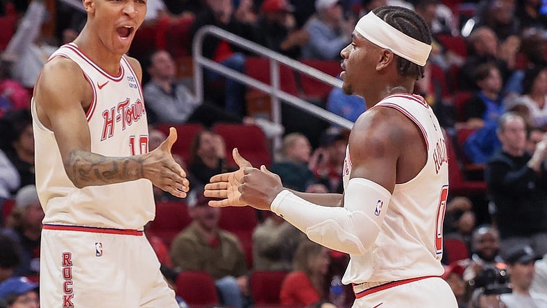 Dec 6, 2023; Houston, Texas, USA;  Houston Rockets forward Jabari Smith Jr. (10) reacts a basket by guard Aaron Holiday (0) against the Oklahoma City Thunder in the second half at Toyota Center. Mandatory Credit: Thomas Shea-USA TODAY Sports