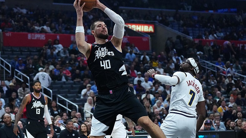 Dec 6, 2023; Los Angeles, California, USA; LA Clippers center Ivica Zubac (40) shoots the ball against Denver Nuggets guard Reggie Jackson (7) in the first half at Crypto.com Arena. Mandatory Credit: Kirby Lee-USA TODAY Sports
