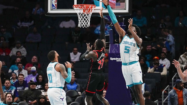 Dec 8, 2023; Charlotte, North Carolina, USA; Charlotte Hornets center Mark Williams (5) blocks a shot by Toronto Raptors guard Dennis Schroder (17)  during the first quarter at the Spectrum Center. Mandatory Credit: Jim Dedmon-USA TODAY Sports