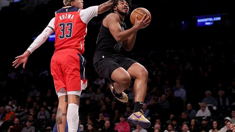 Dec 8, 2023; Brooklyn, New York, USA; Brooklyn Nets guard Cam Thomas (24) drives to the basket against Washington Wizards forward Kyle Kuzma (33) during the first quarter at Barclays Center. Mandatory Credit: Brad Penner-USA TODAY Sports