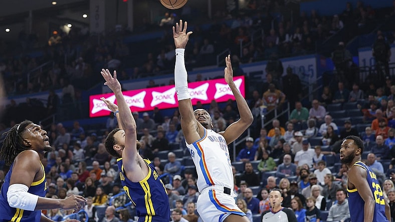 Dec 8, 2023; Oklahoma City, Oklahoma, USA; Oklahoma City Thunder guard Shai Gilgeous-Alexander (2) shoots against Golden State Warriors guard Stephen Curry (30) during the first quarter at Paycom Center. Mandatory Credit: Alonzo Adams-USA TODAY Sports