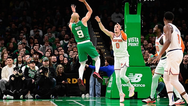 Dec 8, 2023; Boston, Massachusetts, USA;  Boston Celtics guard Derrick White (9) shoots over New York Knicks guard Donte DiVincenzo (0) during the first half at TD Garden. Mandatory Credit: Eric Canha-USA TODAY Sports