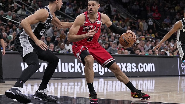 Dec 8, 2023; San Antonio, Texas, USA;  Chicago Bulls center Nikola Vucevic (9) moves against San Antonio Spurs forward Zach Collins (23) in the first half at the Frost Bank Center. Mandatory Credit: Daniel Dunn-USA TODAY Sports