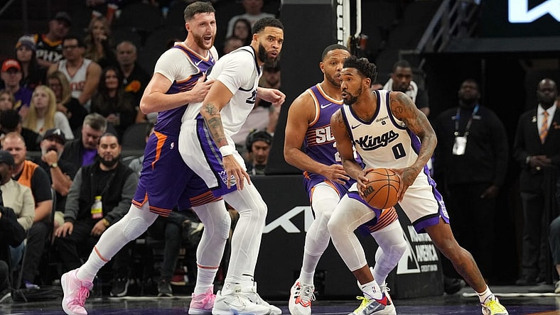 Dec 8, 2023; Phoenix, Arizona, USA; Sacramento Kings guard Malik Monk (0) controls the ball against the Phoenix Suns during the first half at Footprint Center. Mandatory Credit: Joe Camporeale-USA TODAY Sports