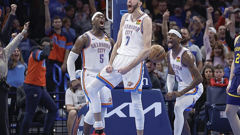 Dec 8, 2023; Oklahoma City, Oklahoma, USA; Oklahoma City Thunder forward Chet Holmgren (7), guard Luguentz Dort (5) and guard Shai Gilgeous-Alexander (2) celebrate after Chet Holmgren scores a basket against the Golden State Warriors during the second half at Paycom Center. Mandatory Credit: Alonzo Adams-USA TODAY Sports