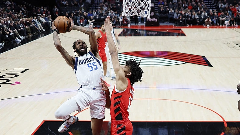 Dec 8, 2023; Portland, Oregon, USA; Dallas Mavericks small forward Derrick Jones Jr. (55) shoots the ball against Portland Trail Blazers shooting guard Shaedon Sharpe (17, right) during the first half at Moda Center. Mandatory Credit: Soobum Im-USA TODAY Sports