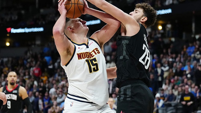 Dec 8, 2023; Denver, Colorado, USA; Houston Rockets center Alperen Sengun (28) blocks a shot by Denver Nuggets center Nikola Jokic (15) in the second half at Ball Arena. Mandatory Credit: Ron Chenoy-USA TODAY Sports