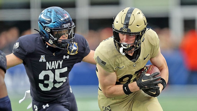 Dec 9, 2023; Foxborough, Massachusetts, USA; Army Black Knights wide receiver Casey Reynolds (87) is chased by Navy Midshipmen safety Kush'i Abraham (35) during the first half of the Army-Navy Game at Gillette Stadium. Mandatory Credit: Danny Wild-USA TODAY Sports