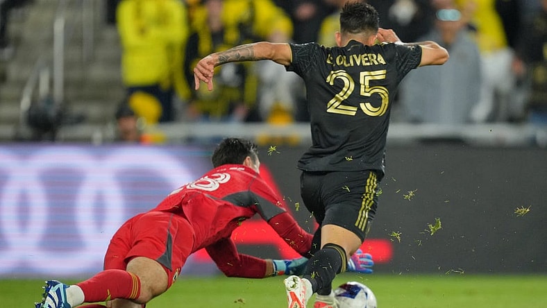 Dec 9, 2023; Columbus, OH, USA; Columbus Crew goalkeeper Patrick Schulte (28) makes a save against Los Angeles FC forward Cristian Olivera (25) during the second half in the 2023 MLS Cup championship game at Lower.com Field. Mandatory Credit: Aaron Doster-USA TODAY Sports