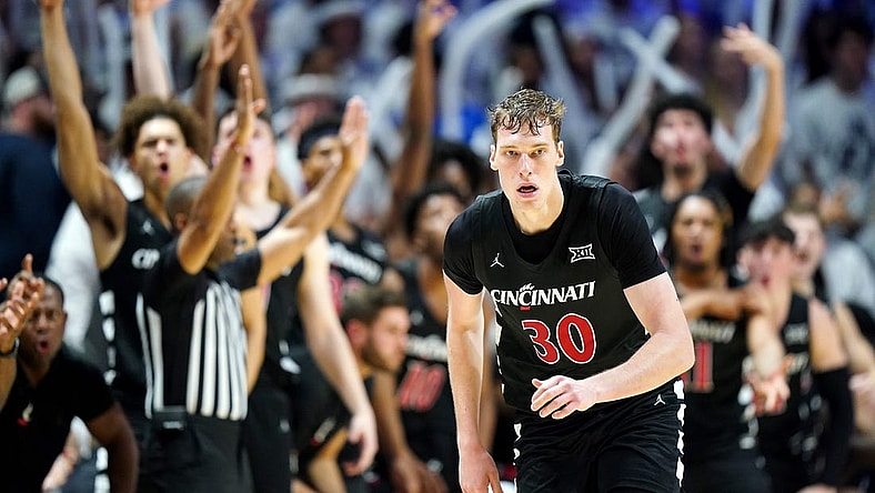 The Cincinnati Bearcats bench reacts to a made 3-point basket by Cincinnati Bearcats forward Viktor Lakhin (30) in the first half of the 91st Crosstown Shootout basketball game between the Cincinnati Bearcats and the Xavier Musketeers, Saturday, Dec. 9, 2023, at Cintas Center in Cincinnati. The Xavier Musketeers won, 84-79.