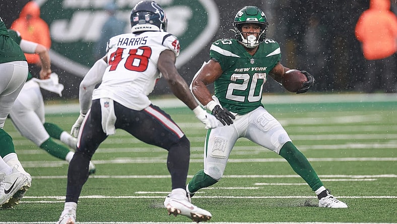 Dec 10, 2023; East Rutherford, New Jersey, USA; New York Jets running back Breece Hall (20) carries the ball asHouston Texans linebacker Christian Harris (48) pursues during the first half at MetLife Stadium. Mandatory Credit: Vincent Carchietta-USA TODAY Sports