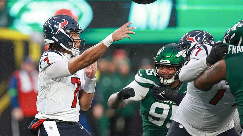 Dec 10, 2023; East Rutherford, New Jersey, USA; Houston Texans quarterback C.J. Stroud (7) throws the ball asNew York Jets defensive tackle Quinnen Williams (95) pursues during the second half at MetLife Stadium. Stroud was injured on the play and left the game. Mandatory Credit: Vincent Carchietta-USA TODAY Sports
